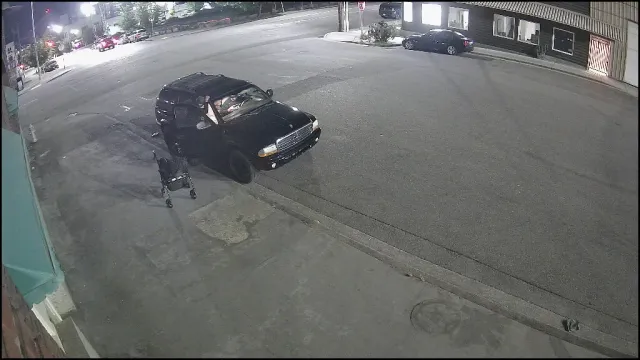 Vigil S2 Low alert — abandoned mobility walker beside an open SUV door in an empty parking lot at night, May 2026