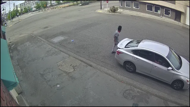 Vigil S3 Medium alert — masked individual leaning over the hood/windshield of a parked silver sedan, May 2026